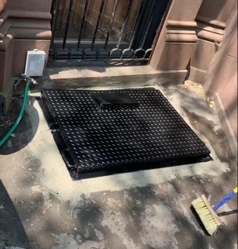 Steel Masters NYC measuring a Brooklyn brownstone stairwell for custom steel staircase fabrication