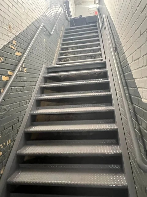 Steel Masters NYC team installing roof railings on a Brooklyn commercial rooftop in Kings County